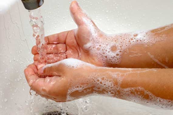 Hands being washed with soap and water