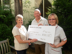 Mr and Mrs Fisher presenting their cheque to Denise Caseley