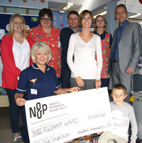 The Cooper family presenting their cheque
